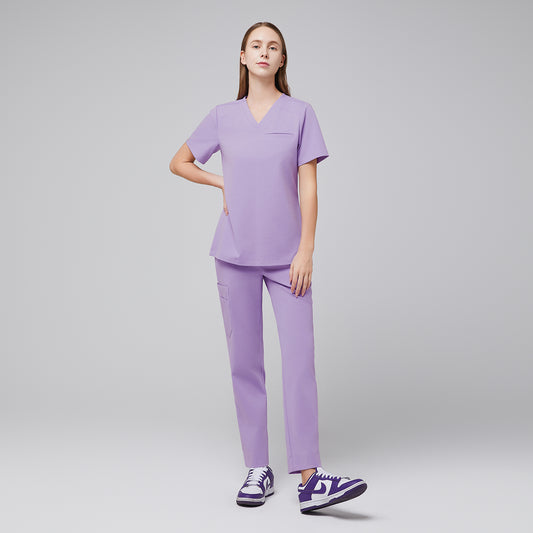 Model wearing lavender V-neck scrub top and matching straight-leg scrub pants with purple sneakers,Lavender