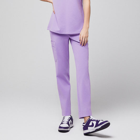 Healthcare professional wearing lavender scrub pants with a side pocket and purple sneakers,Lavender