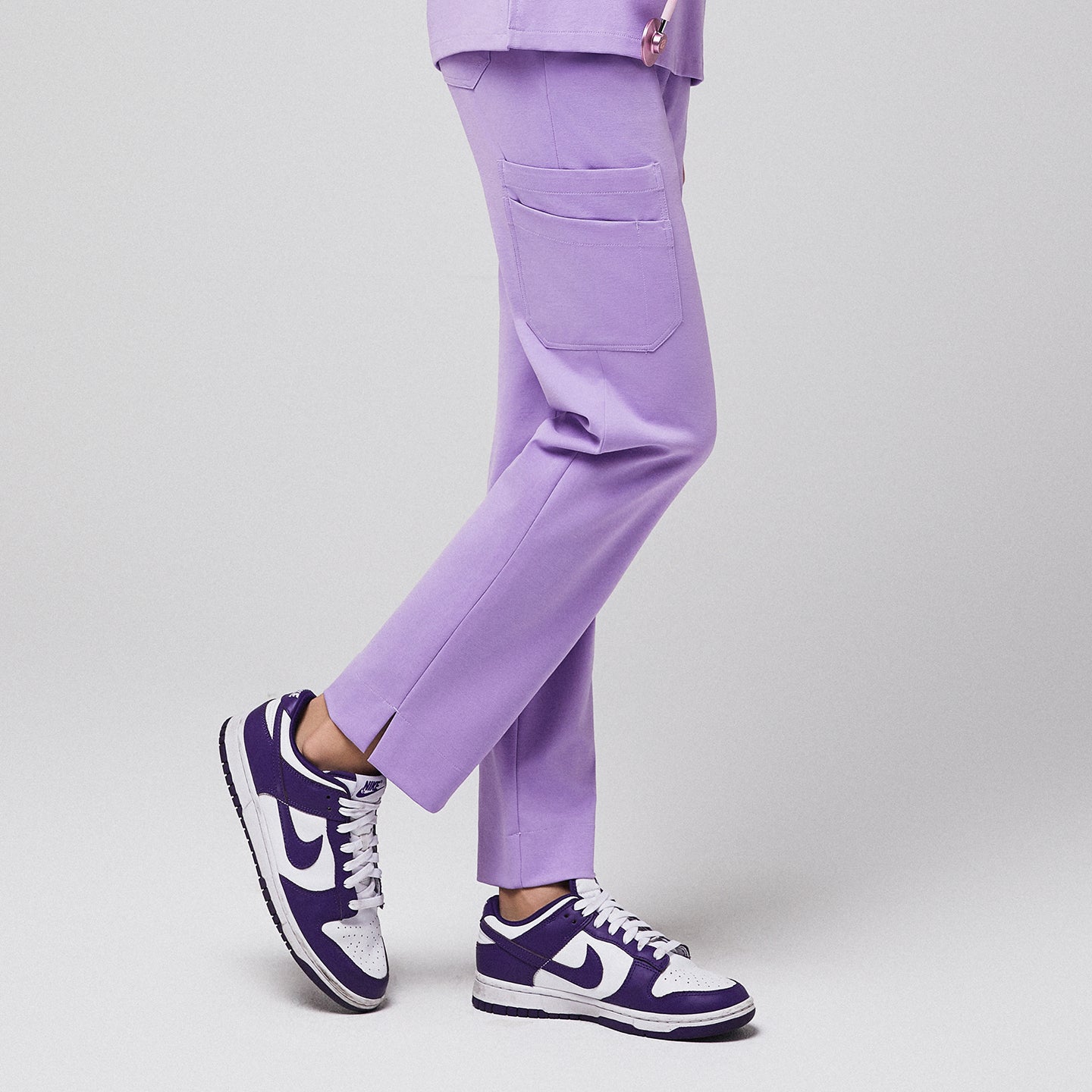 Lavender scrub pants with side pocket and split hem, worn with purple sneakers,Lavender