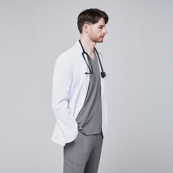 Image of Side view of a man wearing a short white lab coat (LCM-01) over an Ash Gray Single Pocket Scrub Top and Ash Gray StretchFit Jogger Scrub Pants, with his hand in his pocket,White