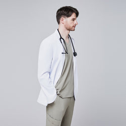 Image of Side view of a man wearing a short white lab coat (LCM-01) over a Sand Khaki Single Pocket Scrub Top and Sand Khaki StretchFit Jogger Scrub Pants, with a stethoscope around his neck,White