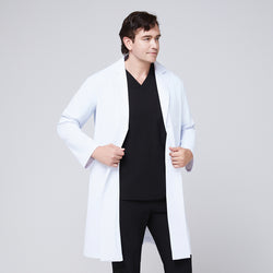 Image of A man wearing a long white lab coat (LCM-02) over an Eco Black Double Pocket Scrub Top and Eco Black Zipper Pocket Straight Scrub Pants, adjusting the front of the coat,White