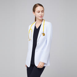 Image of A woman wearing a short white lab coat (LCW-02) over an Eco Navy Double Pocket Scrub Top and Eco Navy Zipper Pocket Jogger Scrub Pants, looking to the side while holding a stethoscope,White