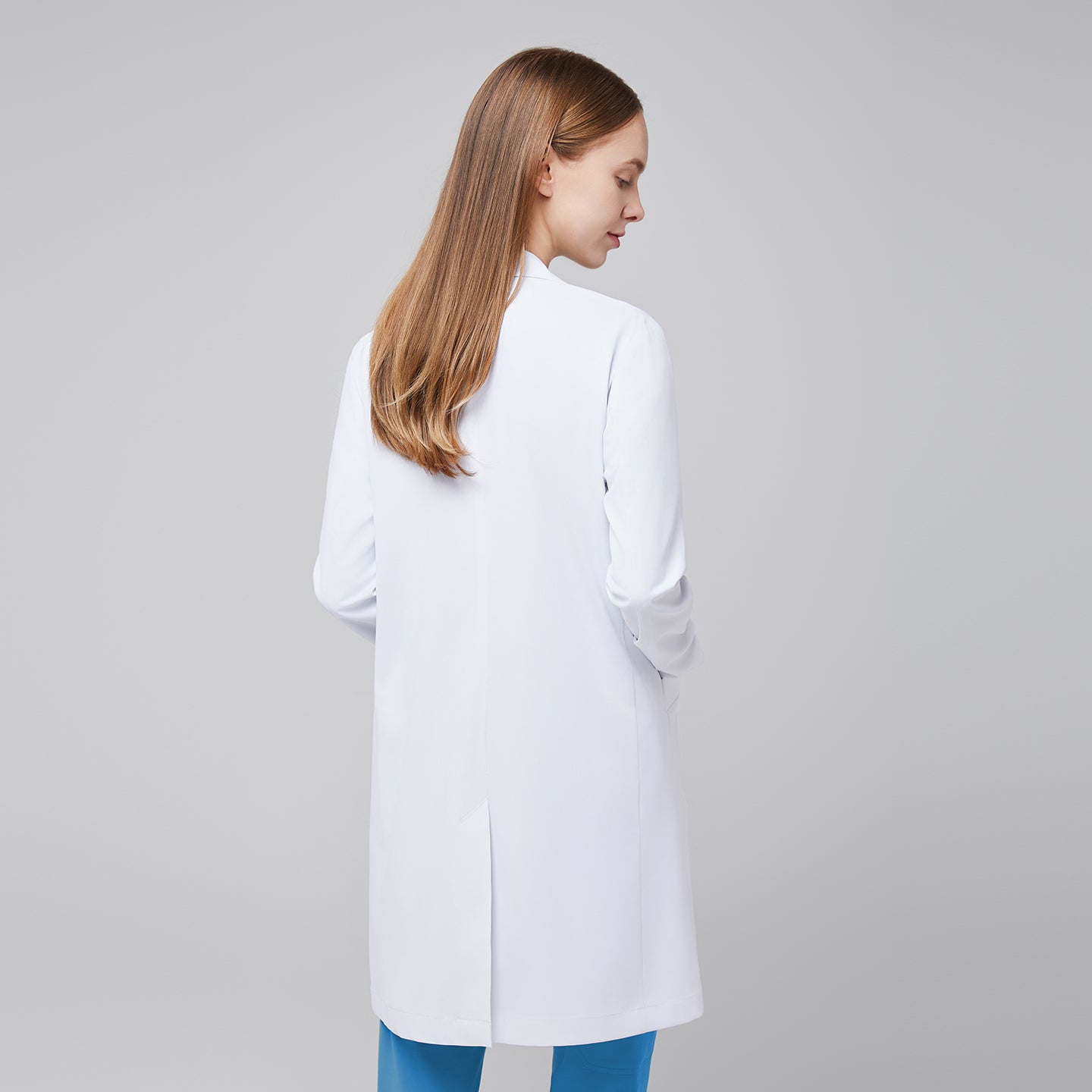 Back view of a woman wearing a white long lab coat (LCW-10) over an Aqua Blue Soft Stretch Scrub Top and Aqua Blue Straight Split Hem Scrub Pants,White





