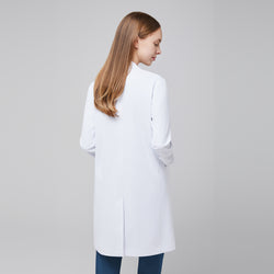 Image of Back view of a woman wearing a white long lab coat (LCW-10) over a Dark Blue Soft Stretch Scrub Top and Dark Blue Split Hem Scrub Pants,White





