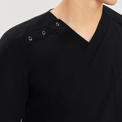 Close-up of a man wearing a V-neck scrub top showing the three snap buttons on the shoulder for easy fastening,Black