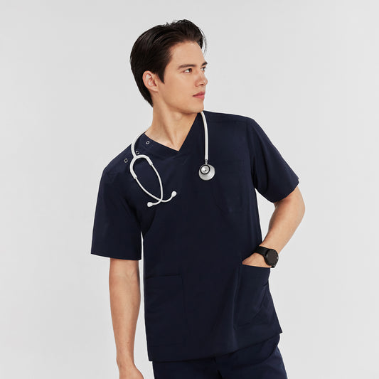 Man wearing a scrub top with three-button shoulder detail, front chest pocket, and a stethoscope around his neck,Navy