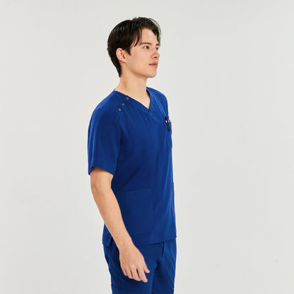 A man standing sideways, wearing a scrub top with a V-neck and three-button detail on the shoulder, showcasing multiple pockets,Royal Blue