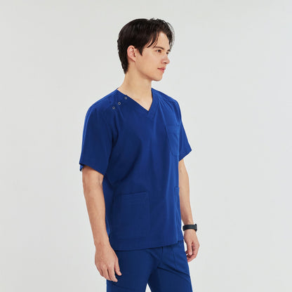 A man standing in a scrub top with a V-neck, three-button shoulder detail, and multiple pockets, looking confidently to the side,Royal Blue