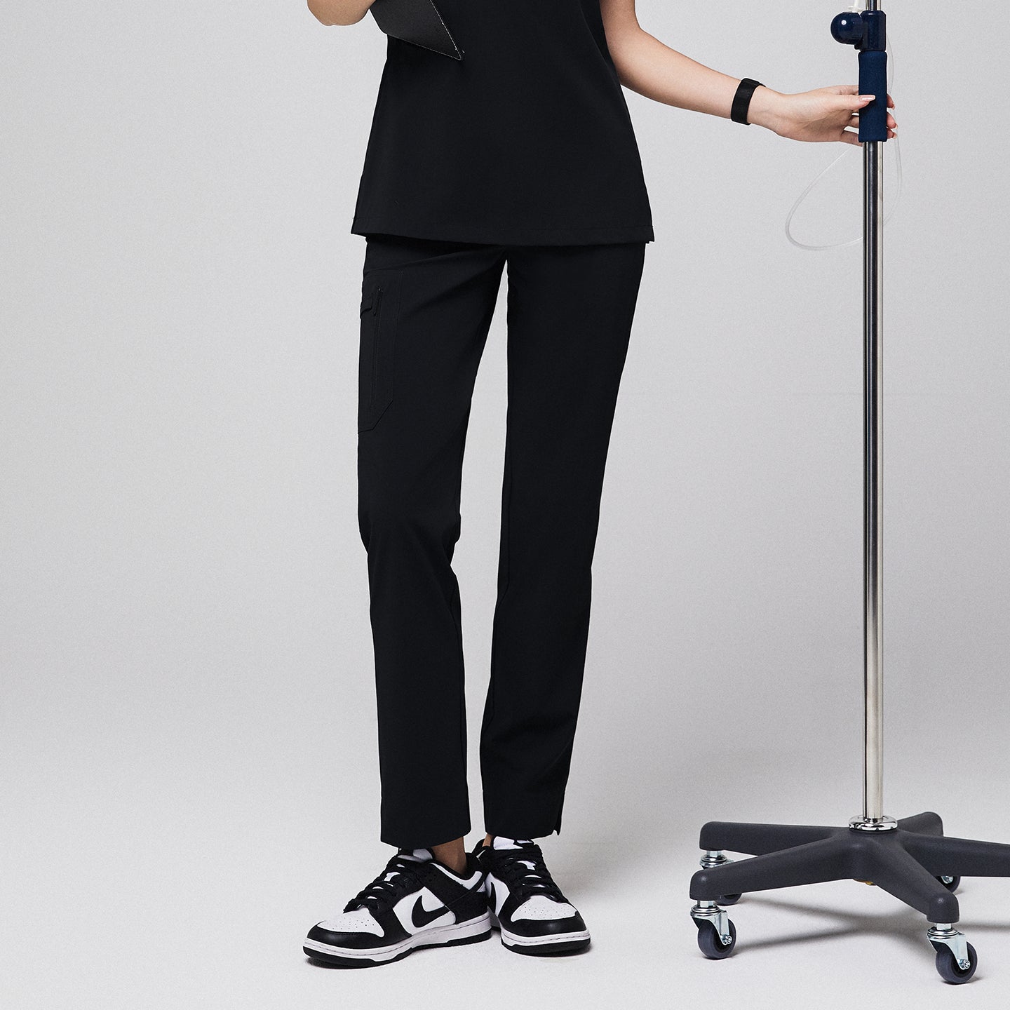 Black scrub pants with zipper pocket and split hem, paired with black sneakers and matching top,Midinight Black