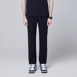 Image of Male model wearing midnight navy relaxed-fit scrub pants with side pocket, standing in a neutral pose, showing the front view of the pants, against a plain background,Midnigh Navy