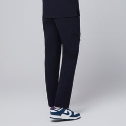 Image of Male model showcasing the back view of midnight navy relaxed-fit scrub pants with a side pocket, emphasizing the details of the rear and side design, against a plain background,Midnigh Navy