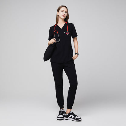 Medical professional wearing jogger-style scrub pants with a stethoscope and carrying a bag,Midnight Black