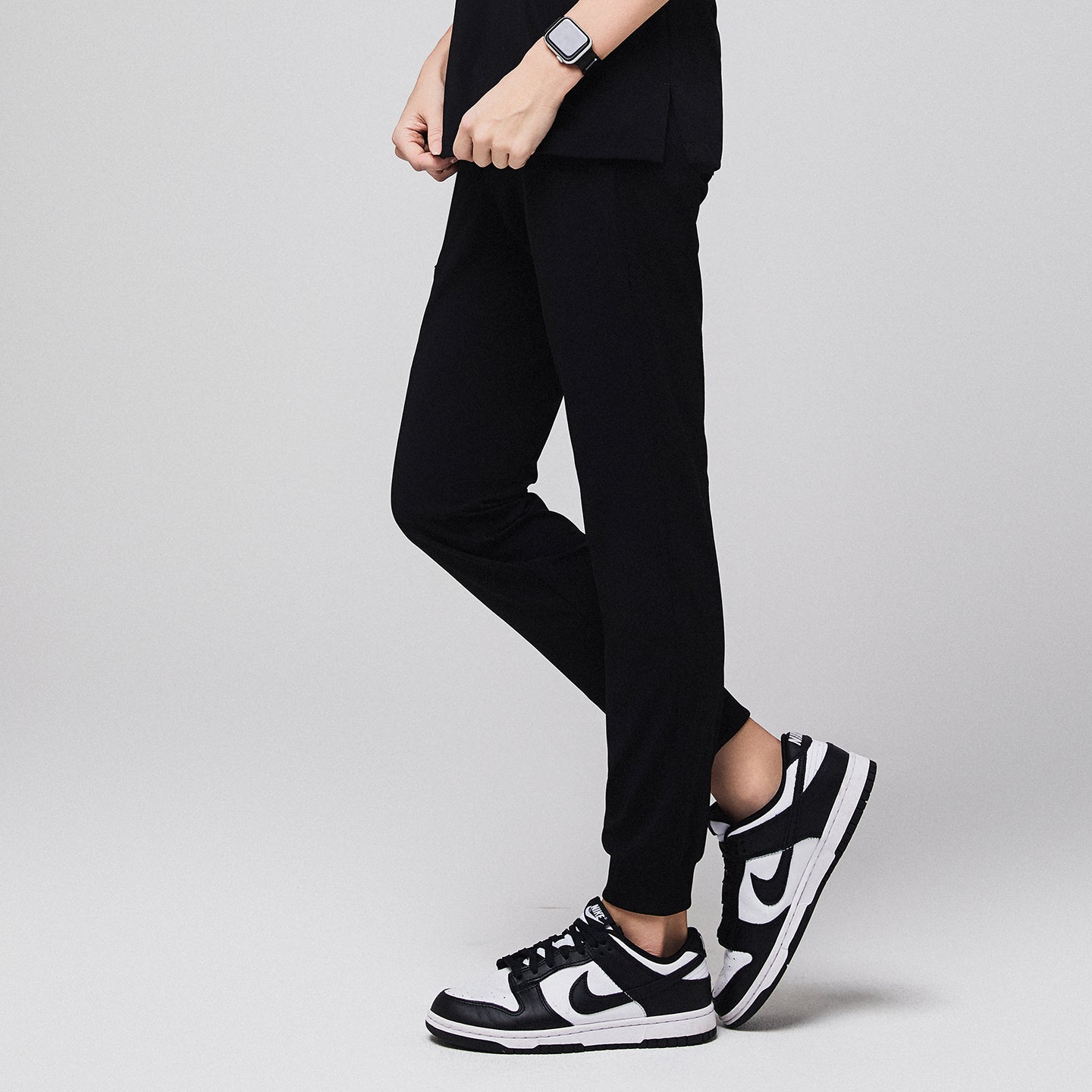 Jogger-style scrub pants worn by a medical professional with sneakers and a smartwatch,Midnight Black