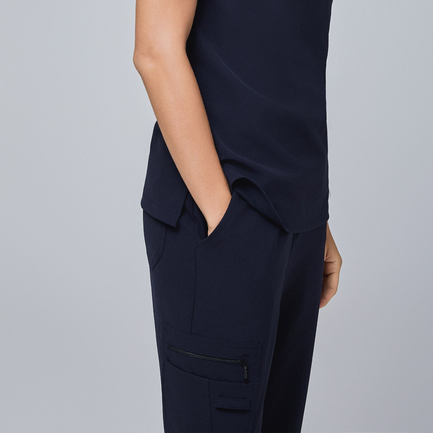 Navy utility scrub pants with a zippered side pocket, worn with a matching navy top,Midnight Navy