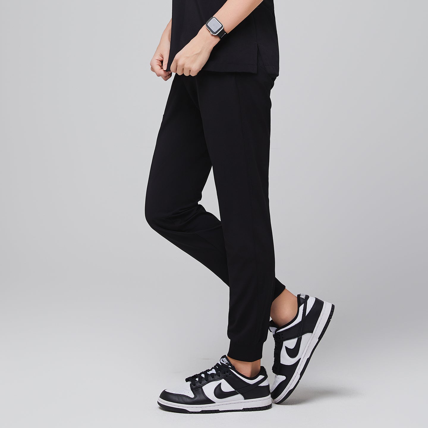 Jogger-style scrub pants worn by a medical professional with sneakers and a smartwatch,Midnight Black