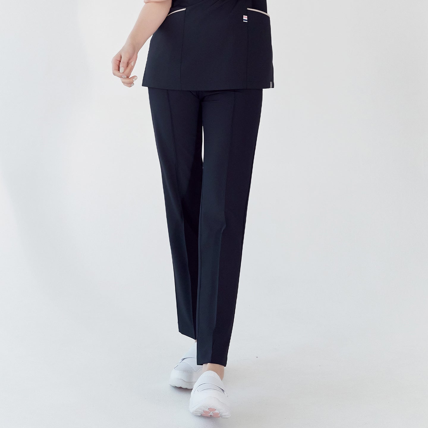 Woman in navy side-banding scrub pants and matching top, standing and showing the front view,Mir Navy