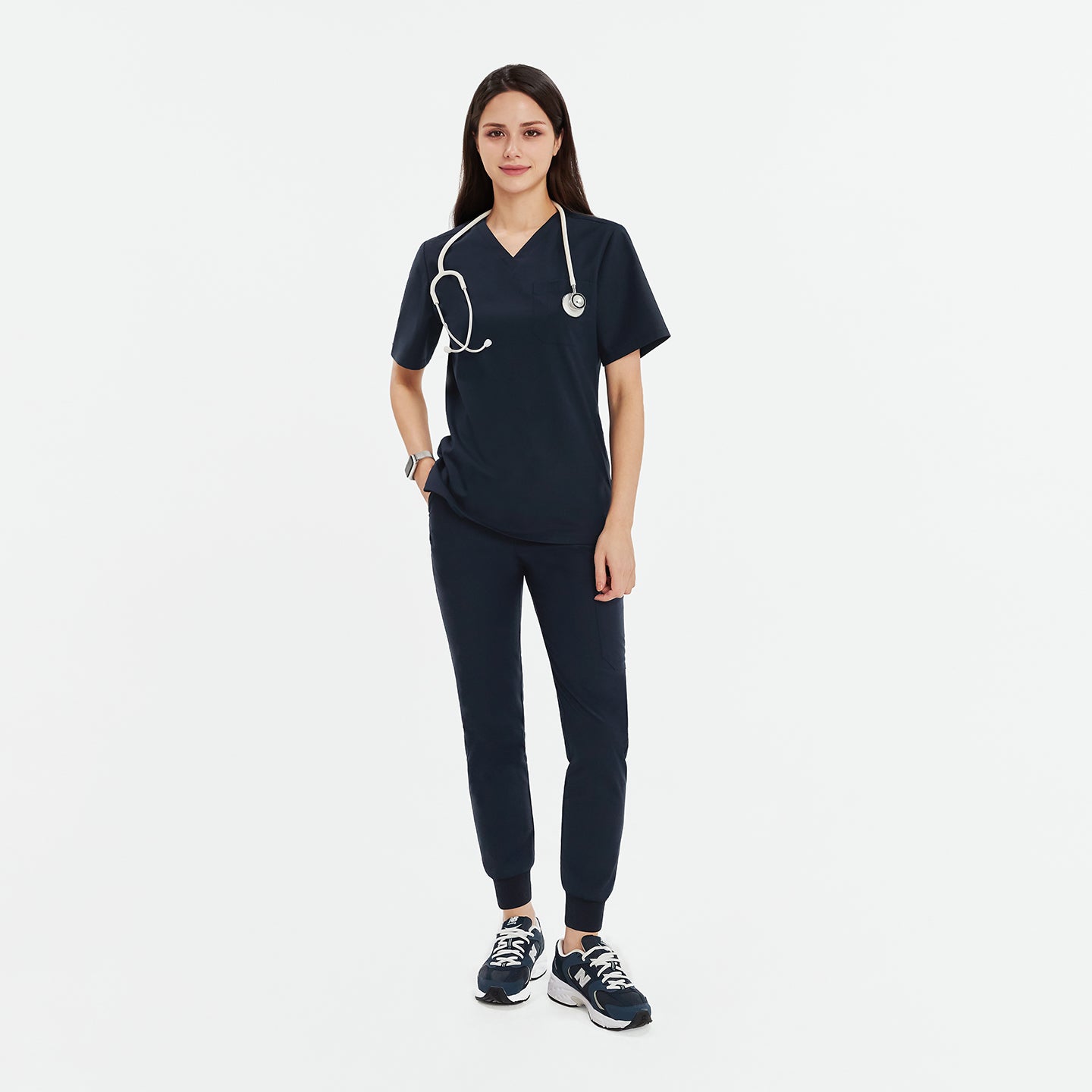 Female model in navy 3-pocket scrub top and jogger-style scrub pants, accessorized with a stethoscope and navy sneakers, showcasing a professional medical uniform,Navy