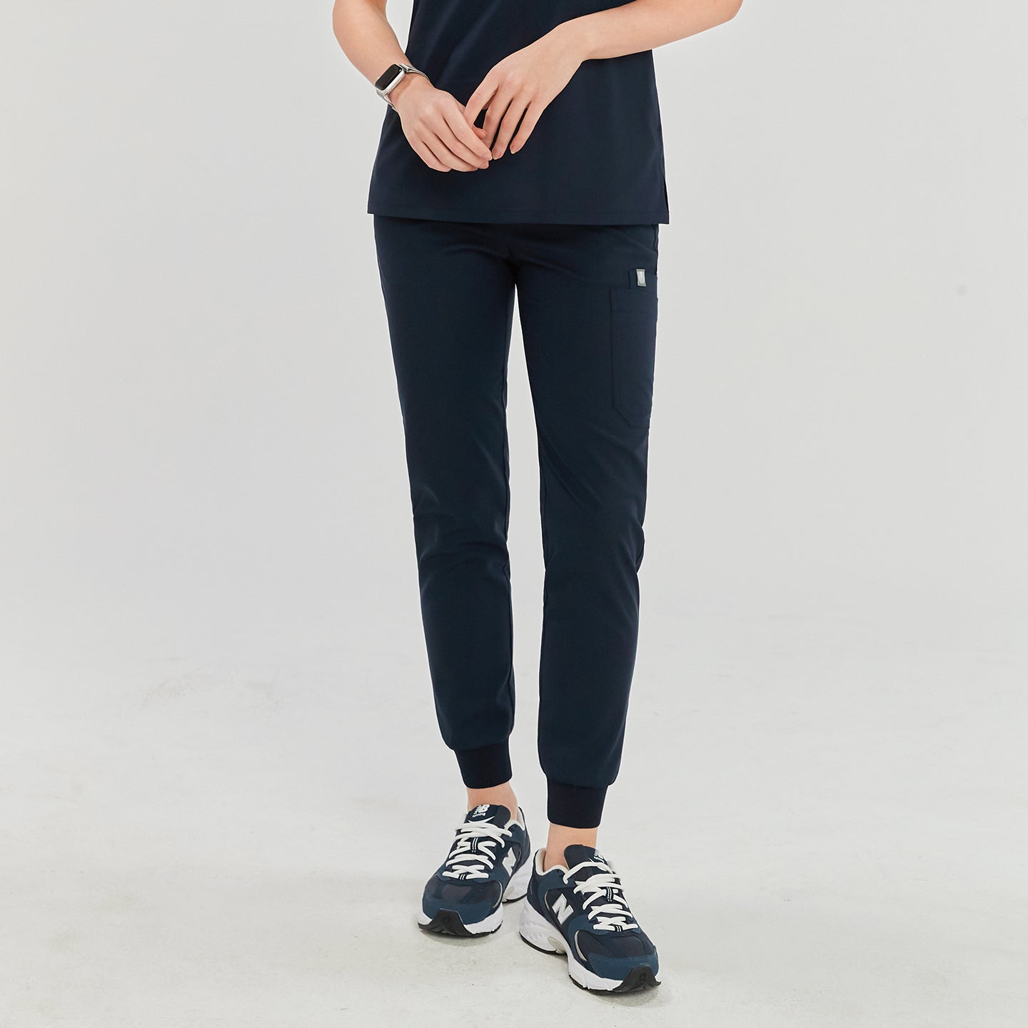 Navy jogger scrub pants with side pocket, paired with navy and white sneakers,Navy