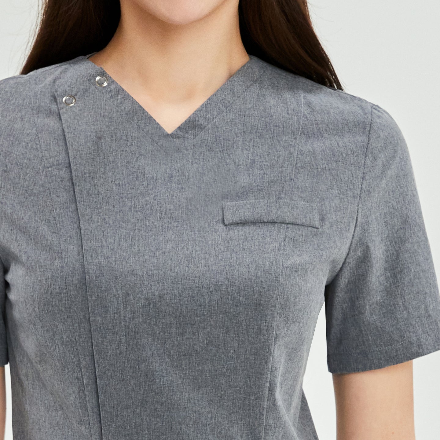 Close-up of the neck detail on a soft gray Zenir front zipper scrub top worn by a woman,Soft Gray