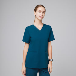 Image of Model wearing an ocean teal double pocket scrub top with matching scrub pants,Ocean Teal