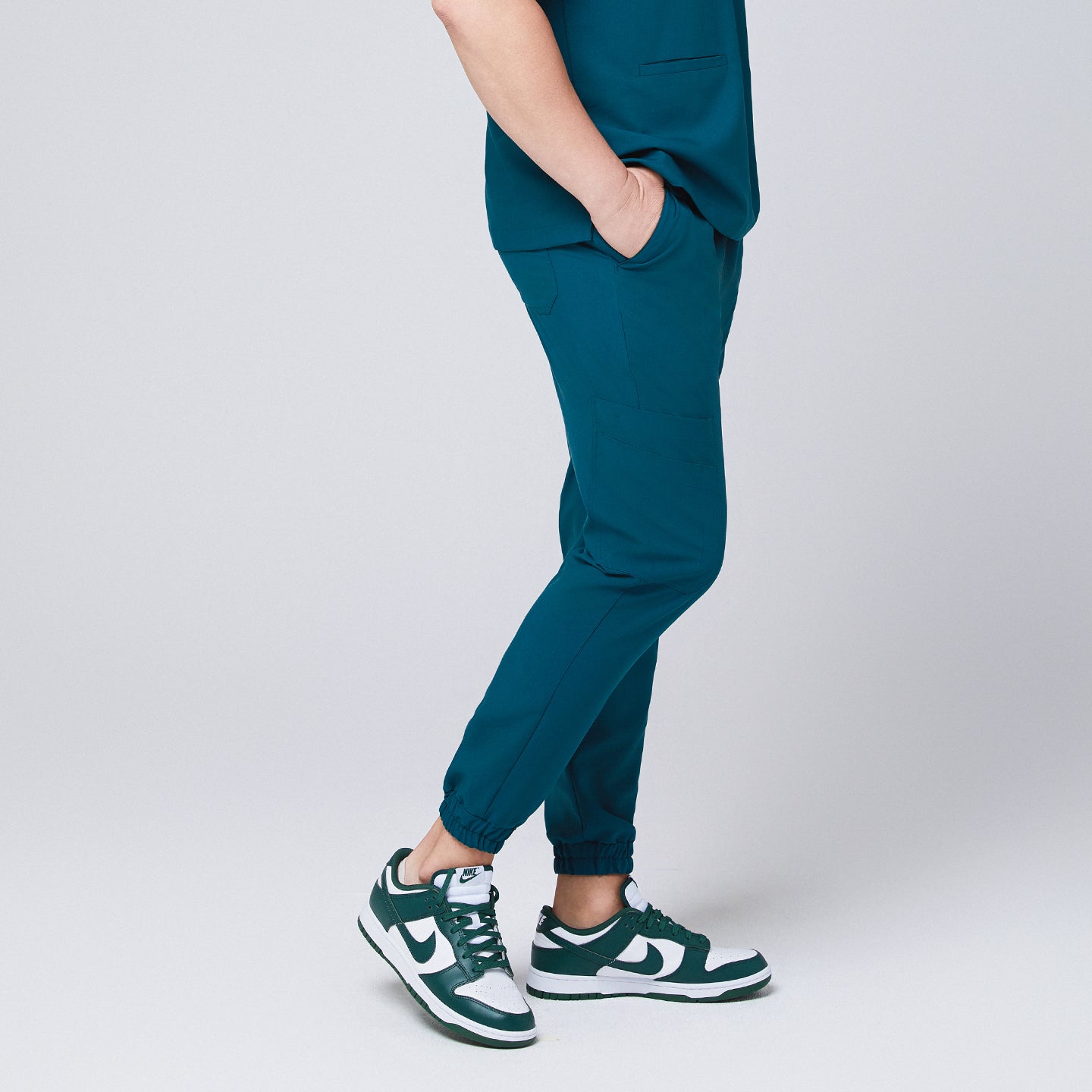 Side view of ocean teal jogger scrub pants with a cargo pocket and elastic cuffs,Ocean Teal 