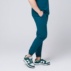 Image of Side view of ocean teal jogger scrub pants with a cargo pocket and elastic cuffs,Ocean Teal 