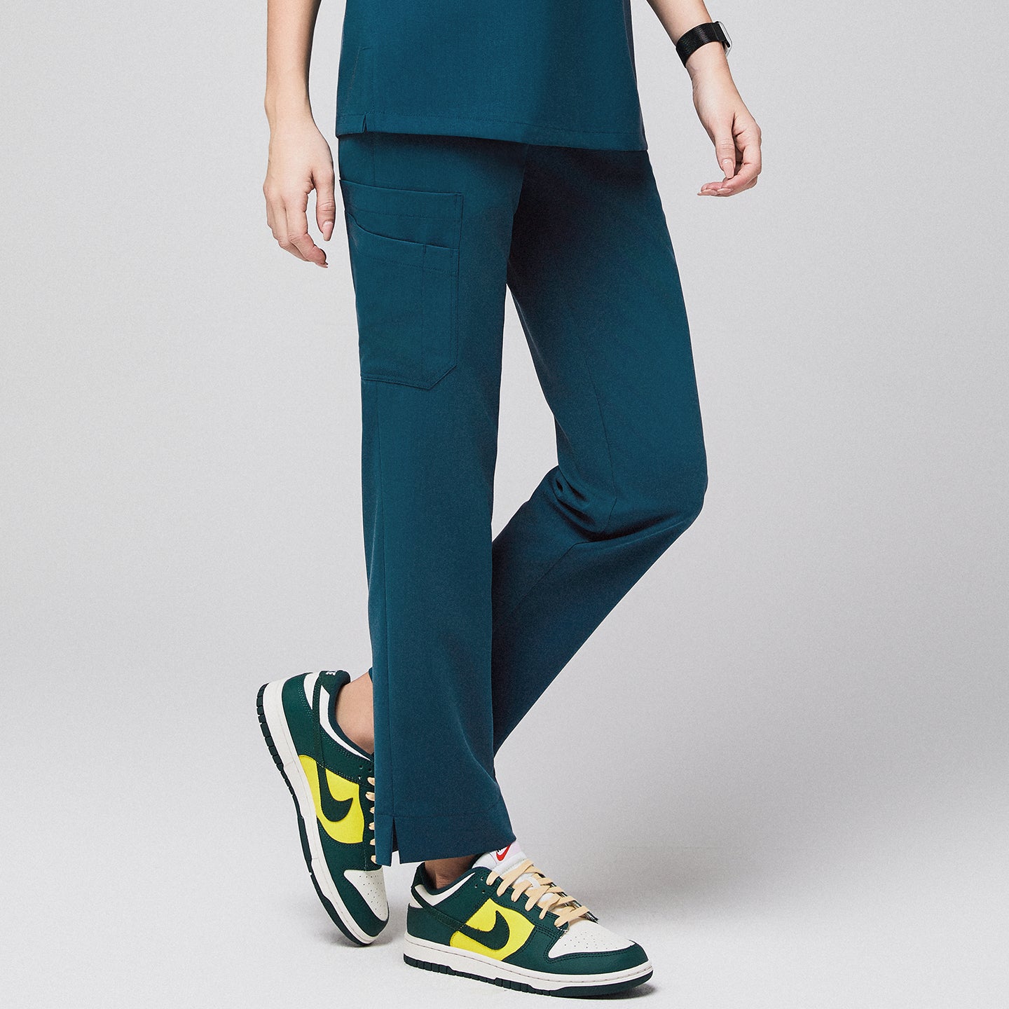 Ocean teal scrub pants with split hem and side pocket, paired with green and yellow sneakers,Ocean Teal