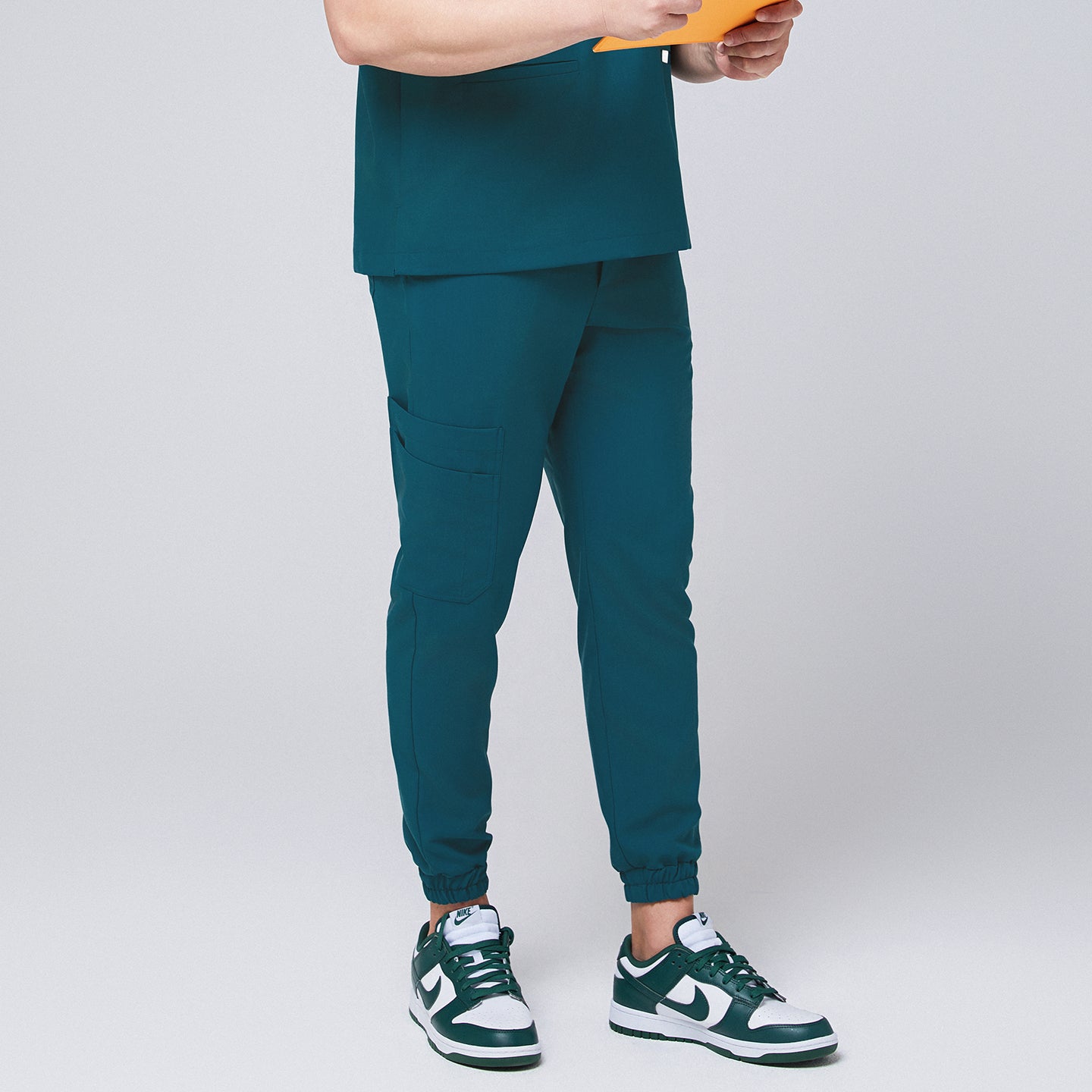 Ocean teal jogger scrub pants made of stretchy fabric and matching ocean teal scrub top, with teal sneakers,Ocean teal