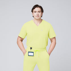 Image of A man wearing a Pineapple Yellow Single Pocket Scrub Top and Pineapple Yellow StretchFit Jogger Scrub Pants, with an ID badge attached to the waist,Pineapple Yellow