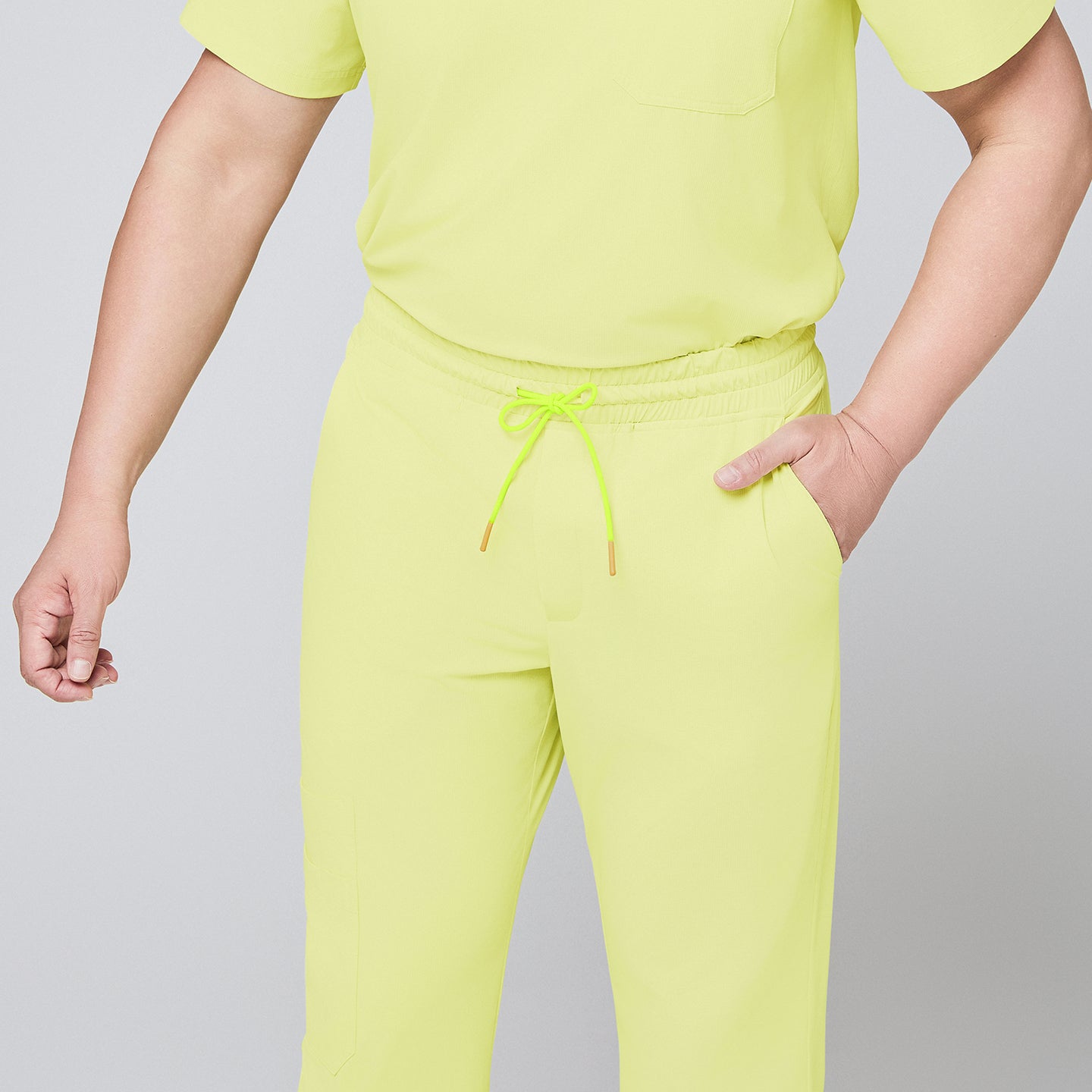 Detailed view of pineapple yellow scrub pants showcasing the elastic drawstring waistband, side pocket design, and a smooth fabric finish,Pineapple Yellow