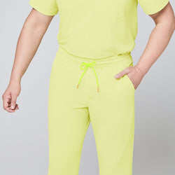 Image of Detailed view of pineapple yellow scrub pants showcasing the elastic drawstring waistband, side pocket design, and a smooth fabric finish,Pineapple Yellow