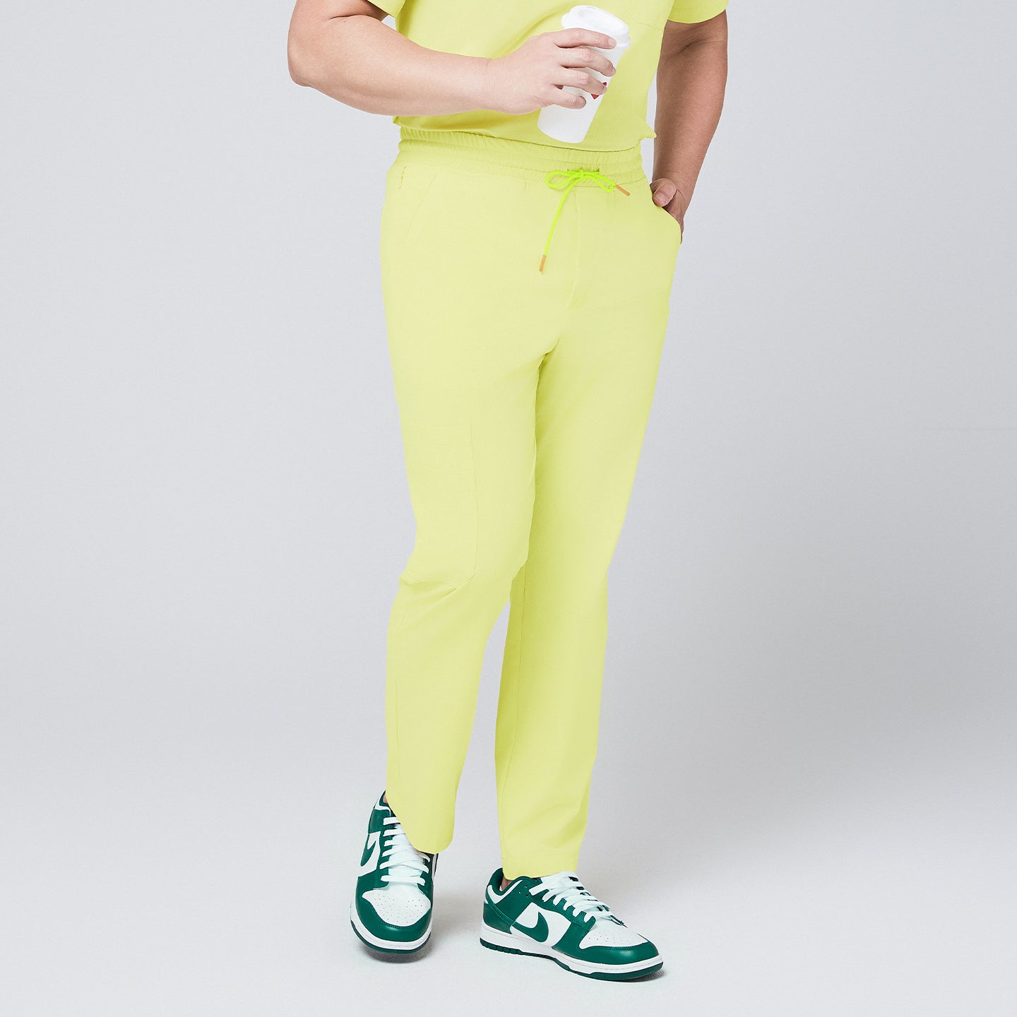 Pineapple yellow straight-leg scrub pants with an adjustable drawstring waistband, paired with matching top and green sneakers,Pineapple Yellow