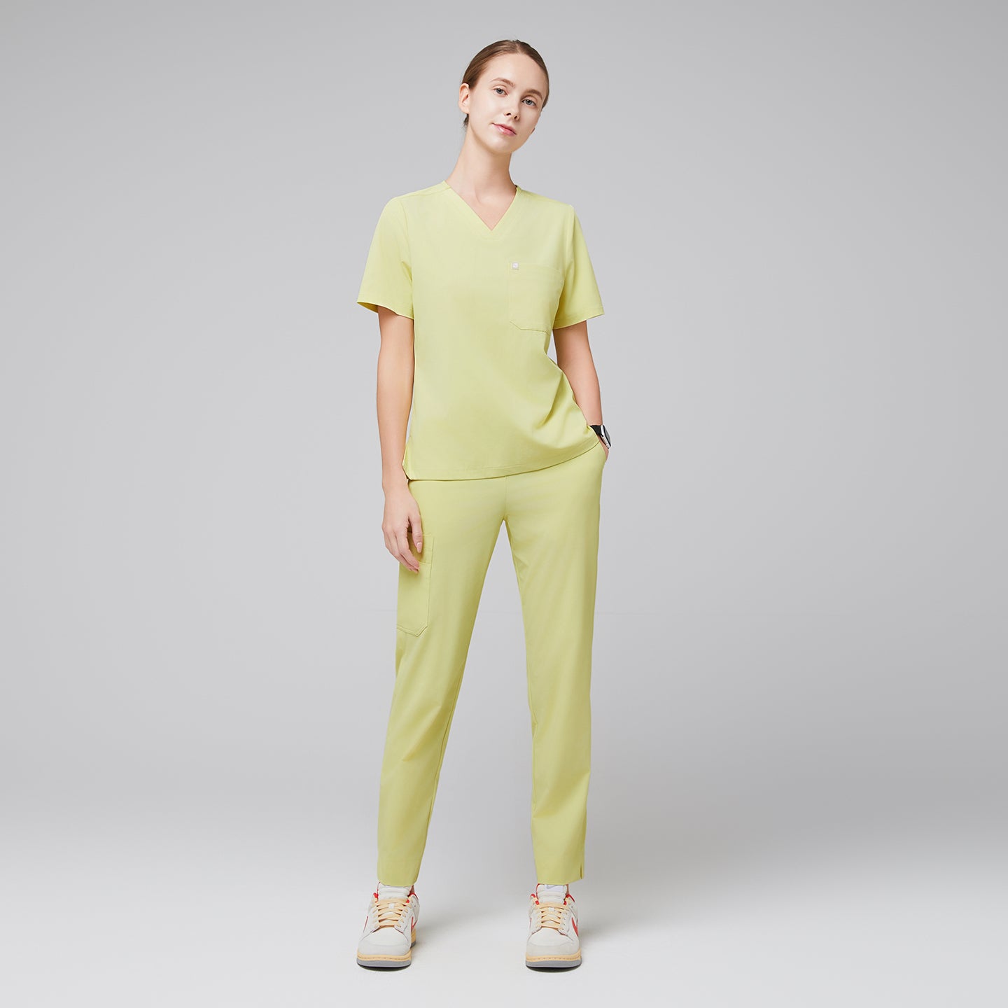 Female wearing pineapple yellow V-neck scrub top and matching pants with beige sneakers,Pineapple Yellow