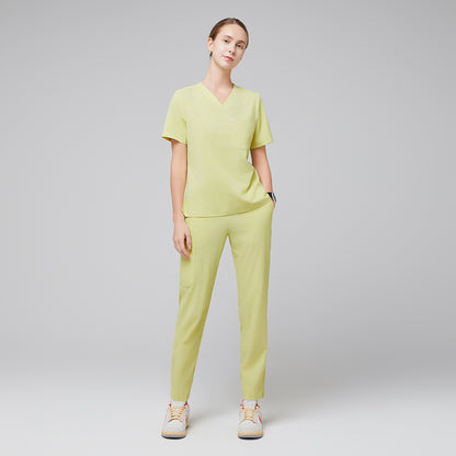 Female wearing pineapple yellow V-neck scrub top and matching pants with beige sneakers,Pineapple Yellow