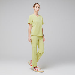 Image of Female wearing pineapple yellow V-neck scrub set with beige and orange sneakers,Pineapple Yellow