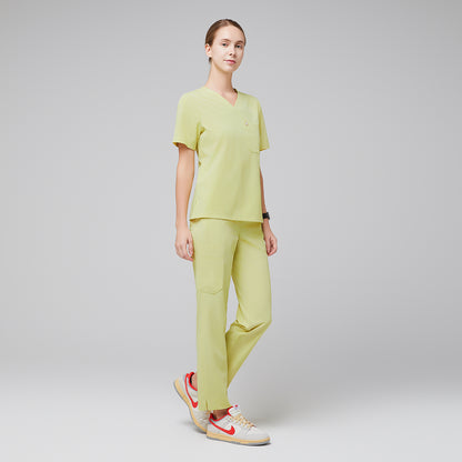 Female wearing pineapple yellow V-neck scrub set with beige and orange sneakers,Pineapple Yellow