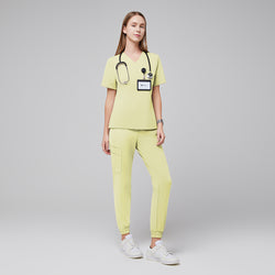 Image of Woman wearing light yellow jogger scrubs with a stethoscope and ID badge, standing confidently in white sneakers,Pineapple Yellow