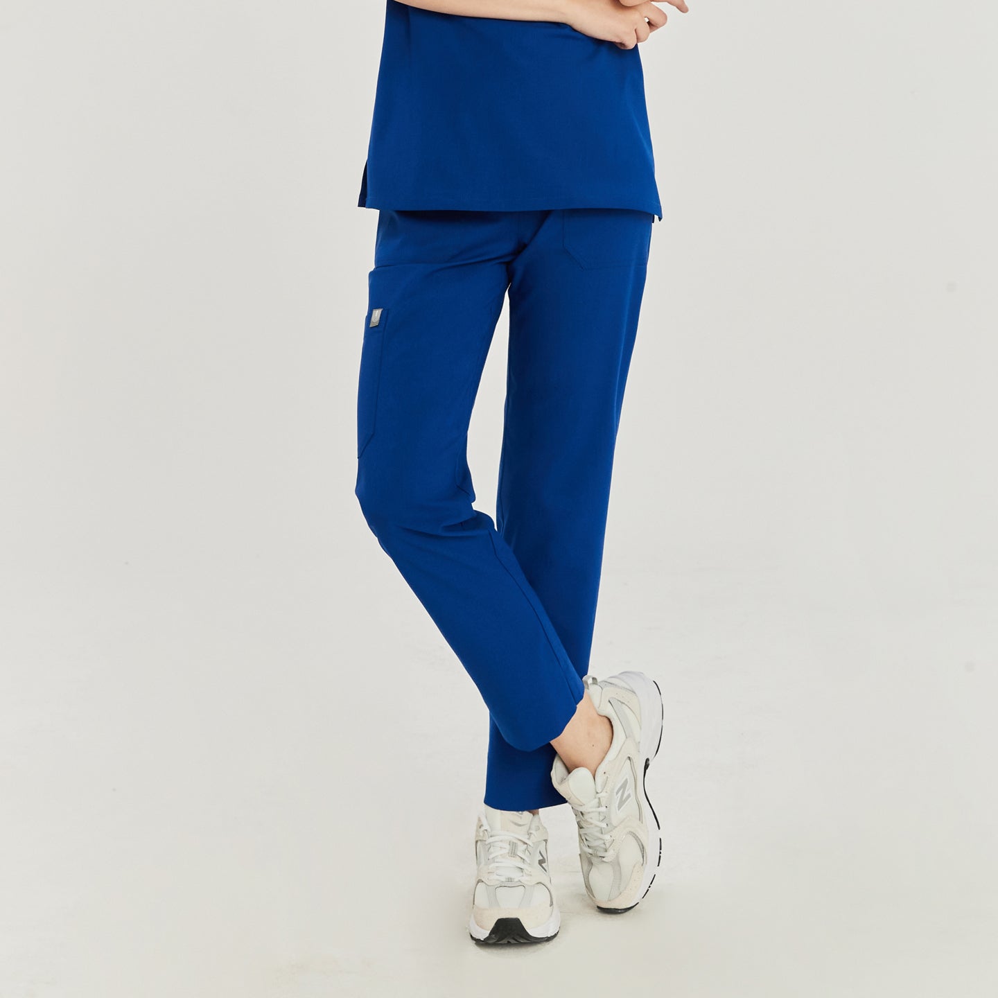 Scrub pants with side pocket and sneakers worn by a medical professional,Royal Blue