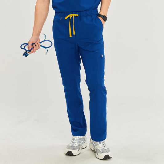 Front view of a model wearing royal blue zipper straight scrub pants with zipper details, a yellow drawstring, and a matching top, paired with white athletic shoes,Royal Blue
