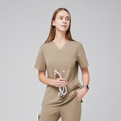 Image of Scrub top with V-neck and chest pocket, styled with matching pants, holding a stethoscope,Sand Beige