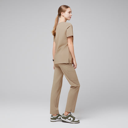 Female wearing sand beige scrub set, viewed from the back, paired with green sneakers,Sand Beige