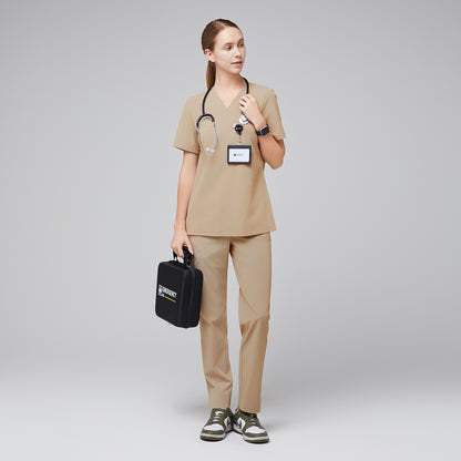 Female wearing sand beige V-neck scrub set, holding a black medical kit, paired with green sneakers,Sand Beige