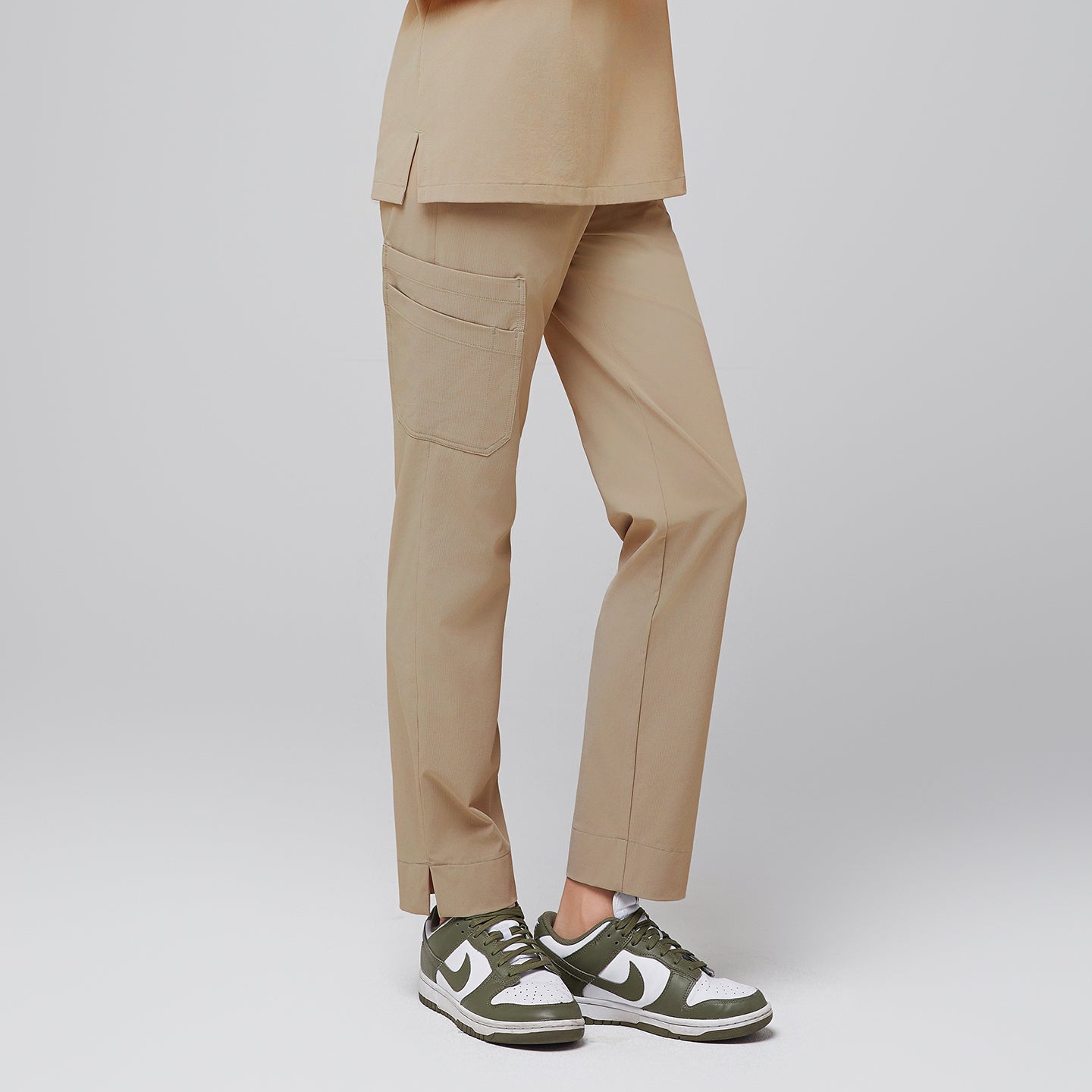 Female wearing sand beige scrub pants with side pocket and green sneakers,Sand Beige