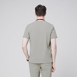 Image of Back view of a male model wearing a sand khaki V-neck single-pocket scrub top,Sand Khaki