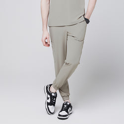 Image of Sand khaki jogger scrub pants with side pocket and elastic cuffs, paired with black and white sneakers,Sand Khaki