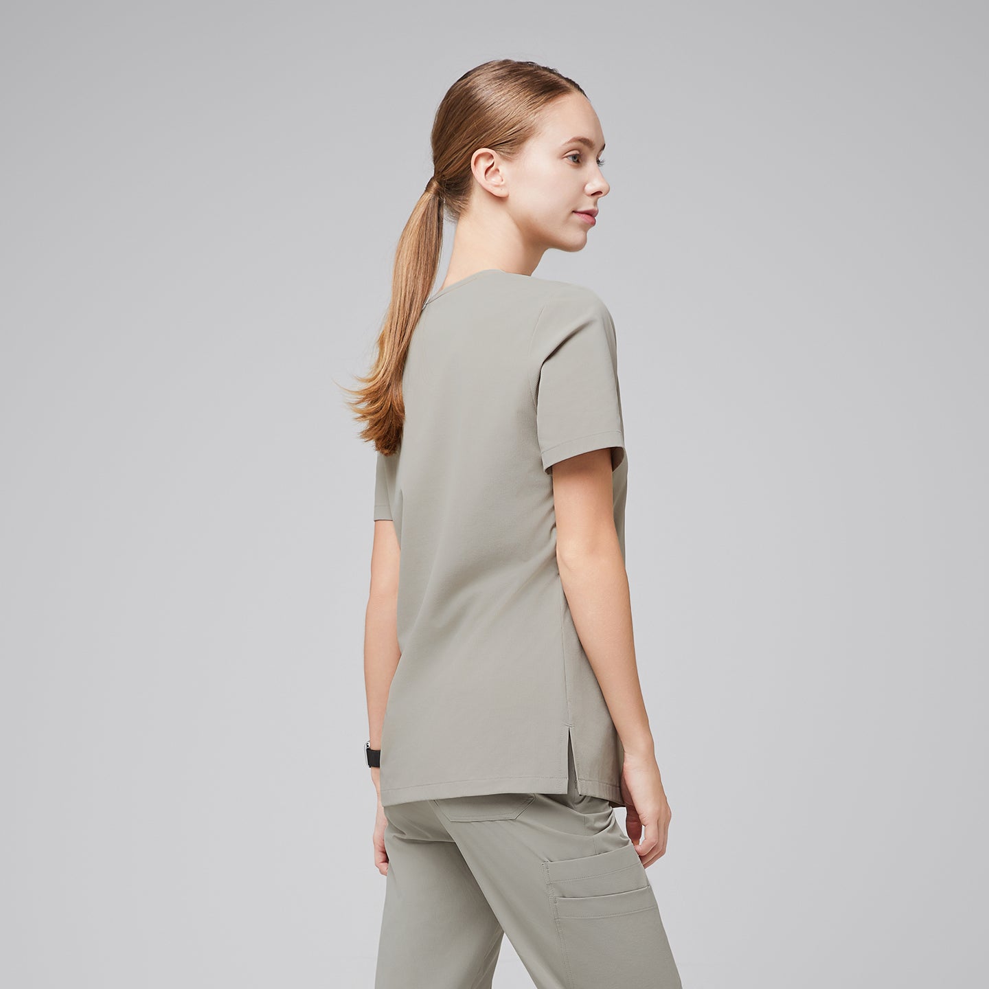 Rear side view of a female healthcare professional wearing a sand khaki scrub top and pants,Sand Khaki