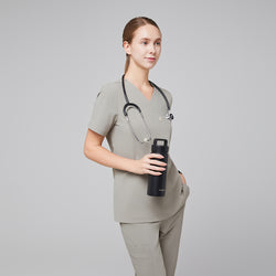 Image of Female healthcare professional in a sand khaki scrub set with a stethoscope, holding a black water bottle,Sand Khaki