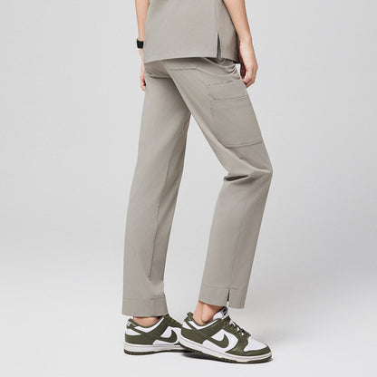 Back view of khaki scrub pants with side pocket and split hem, paired with green sneakers,Sand Khaki