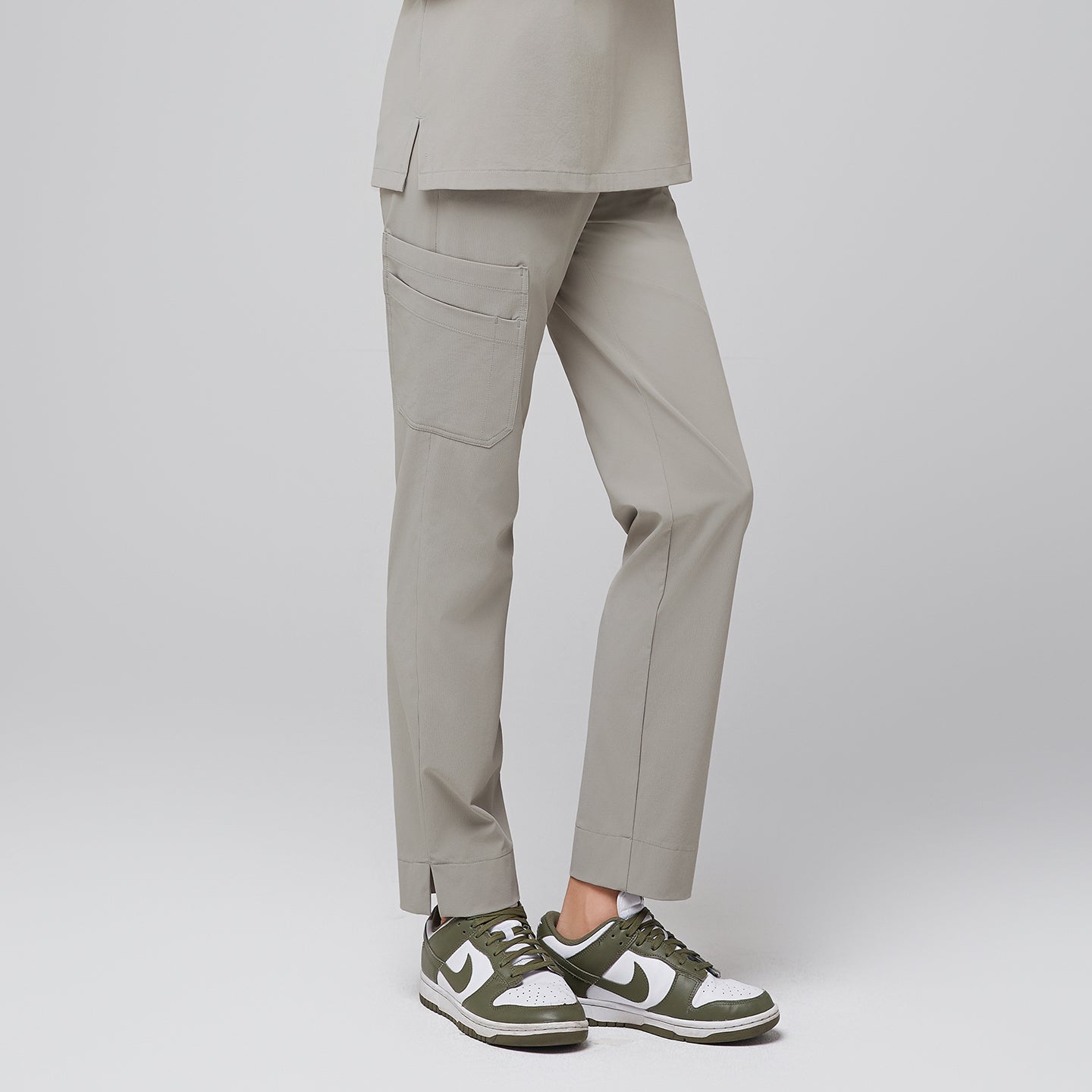 Female wearing sand khaki scrub pants with side pocket, paired with green sneakers,Sand Khaki